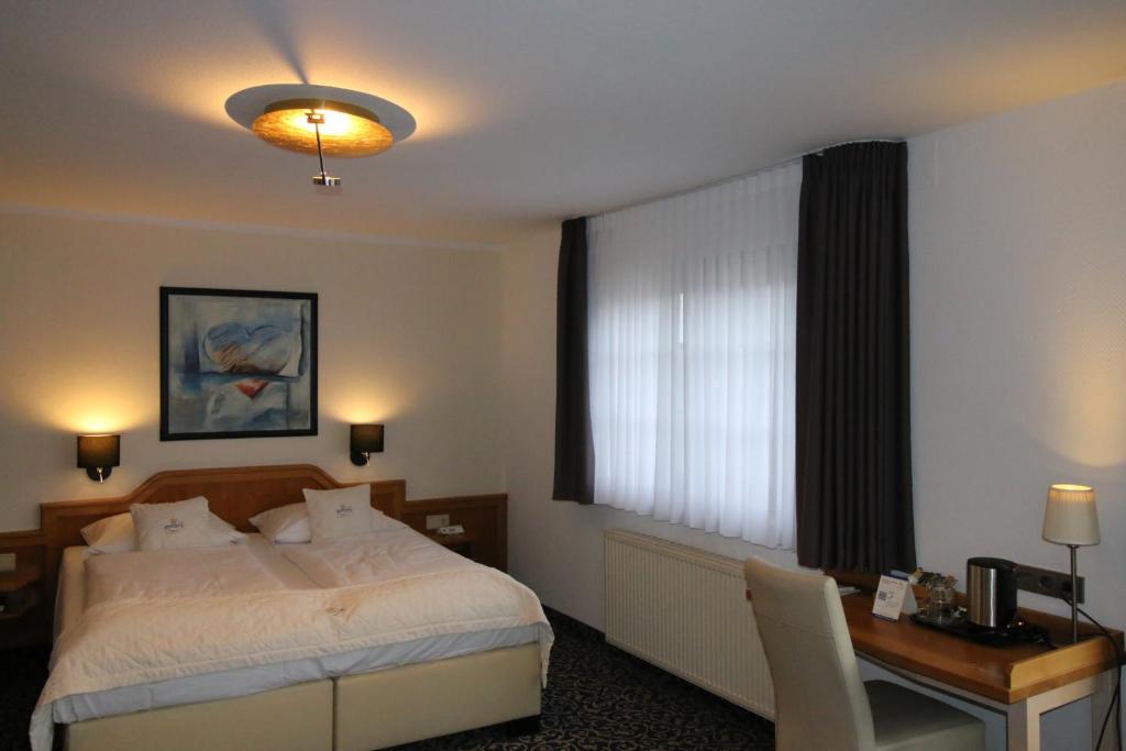 Postel nebo postele na pokoji v ubytování Hotel Trapp