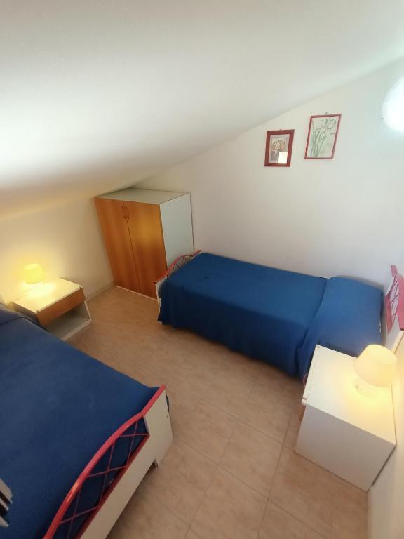 Posteľ alebo postele v izbe v ubytovaní Appartamenti Villa Chiara