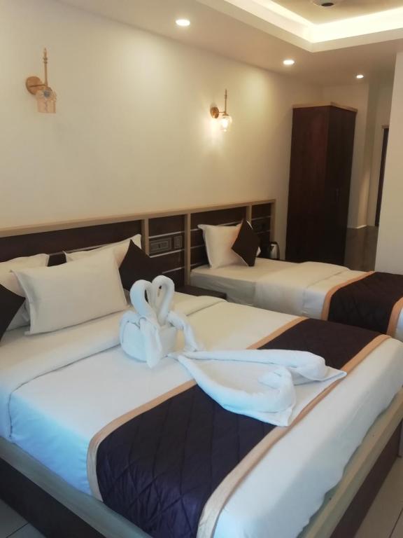 Postel nebo postele na pokoji v ubytování PAUL RESIDENCY