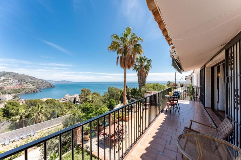 a balcony with chairs and a view of the ocean at CT 269 GR - Faro's Sun, Beach & More in Almuñecar in Almuñécar