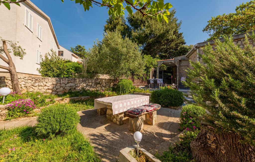 a stone bench in the middle of a garden at 1 Bedroom Stunning Home In Potocnica in Borovići
