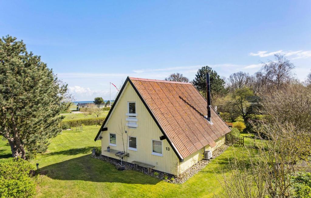 an old house with an orange roof on a field at 3 Bedroom Stunning Home In Rudkbing in Spodsbjerg