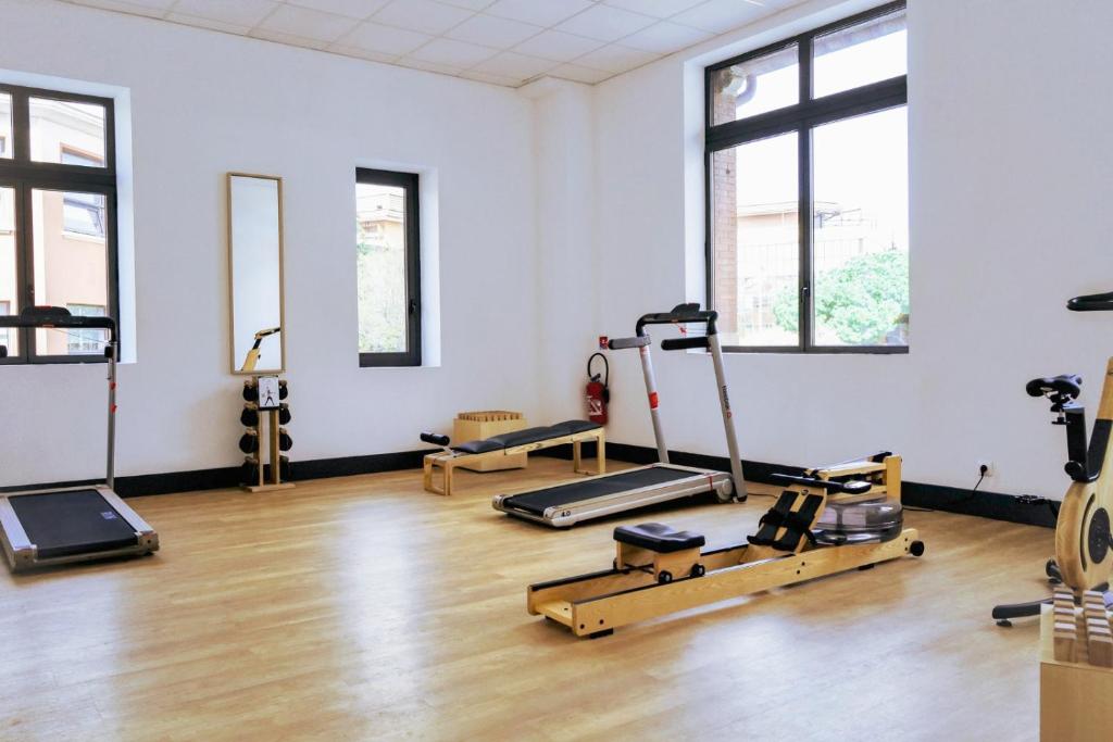 a gym with treadmills and exercise equipment in a room at New Hotel of Marseille - Vieux Port in Marseille