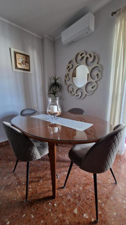 a dining room table with two chairs and a wine glass at Casa Maria in Olivenza