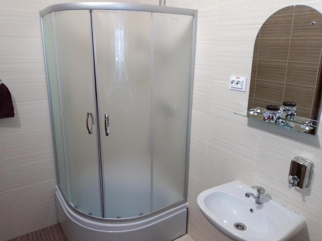 a bathroom with a shower and a sink at Hostel Iskra in Lviv