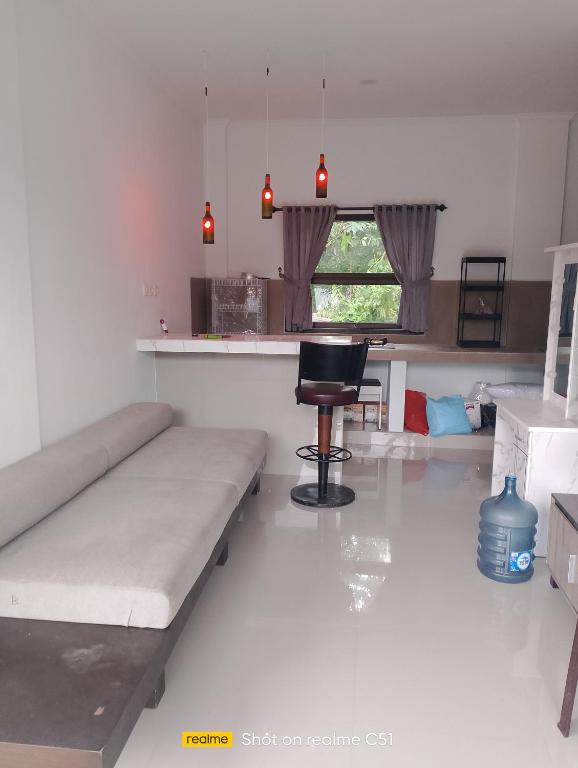 a living room with a couch and a chair in it at Wiwik sweet villa in Amed