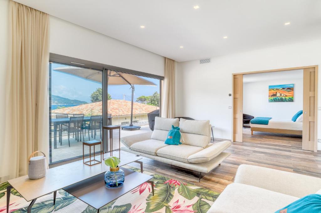 a living room with a couch and a table at Akwabay - Les Villas du Cap in Le Lavandou