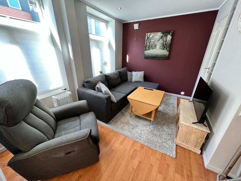 a living room with a couch and a table at Central 1BR Apartment in Narvik