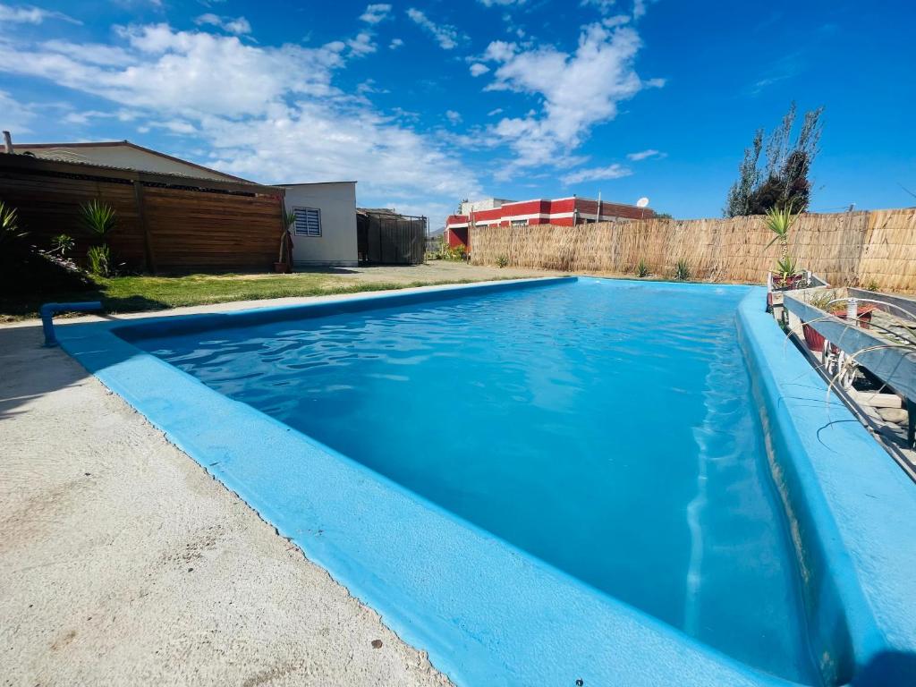 a large blue swimming pool in a yard at Paraíso del Valle in Ovalle
