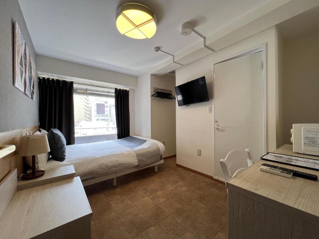 Postel nebo postele na pokoji v ubytování Le Tour Hotel Akihabara Kanda 楽途ホテル神田秋葉原