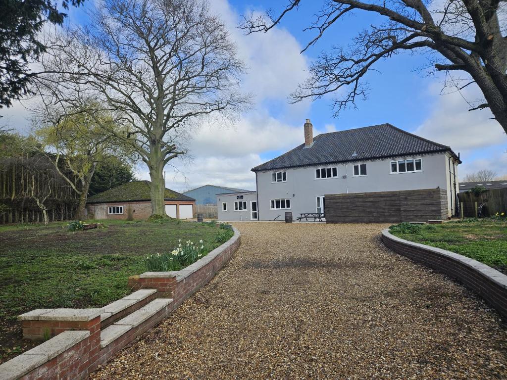 a large white house with a large driveway at The Plough Inn Farmhouse - Private Holiday House in Lenwade