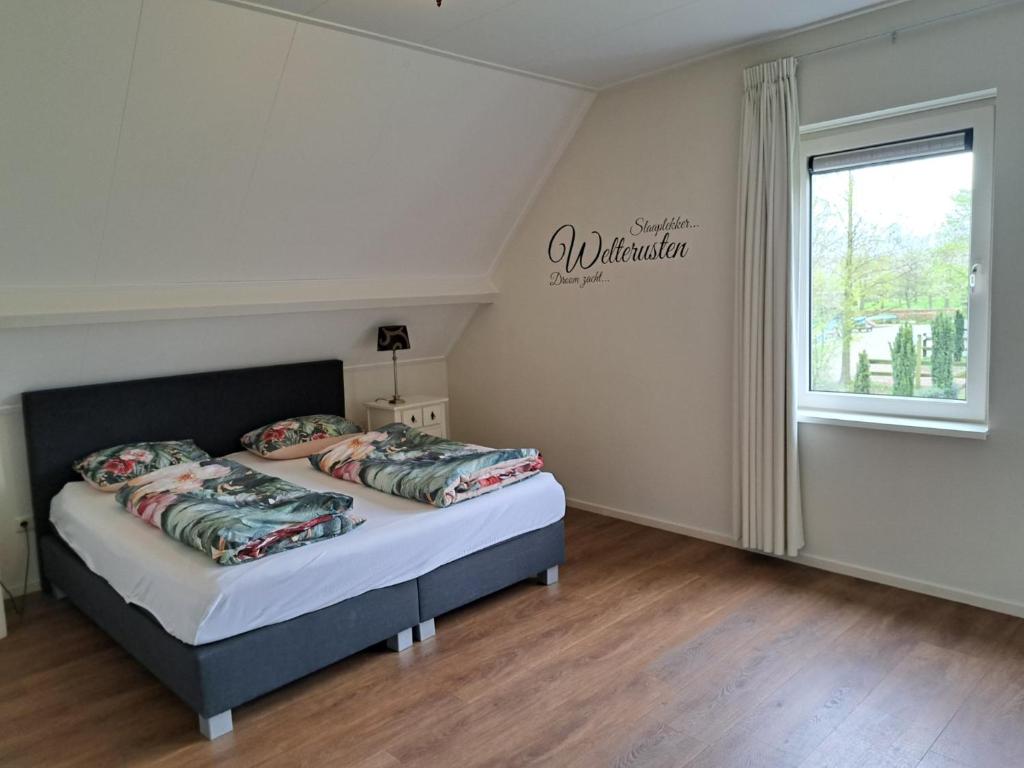 a bedroom with a bed with two pillows on it at Vakantiehuis B&B Familie Versantvoort in Handel