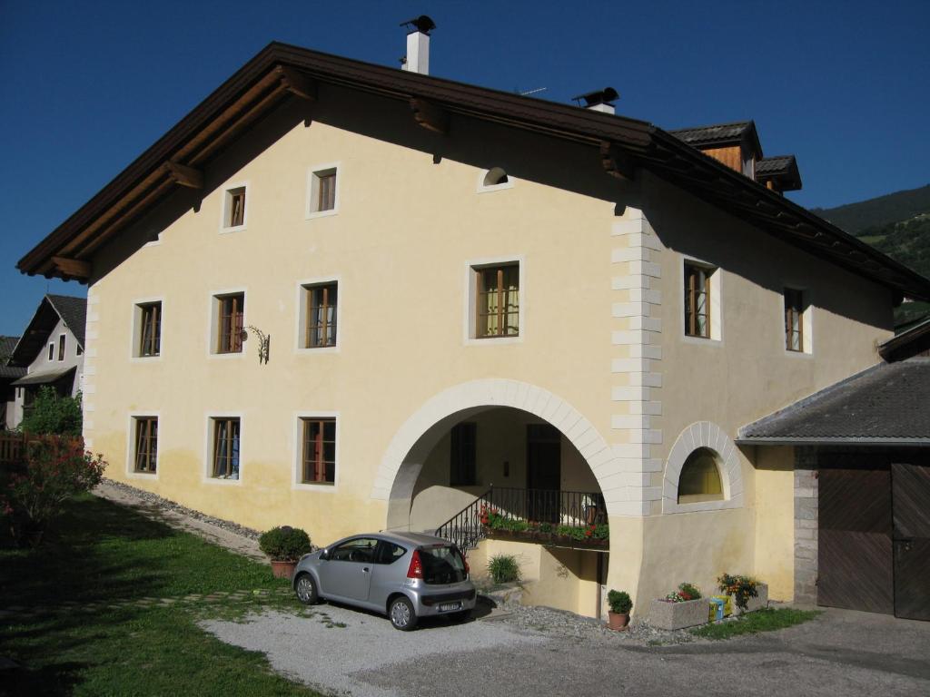 a house with a car parked in front of it at Untermoarhof Albeins in Bressanone