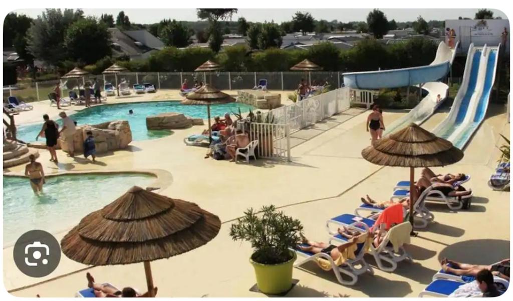 a group of people in a pool at a resort at Mobile-home Camping 4 etoiles bord de mer in Ouistreham