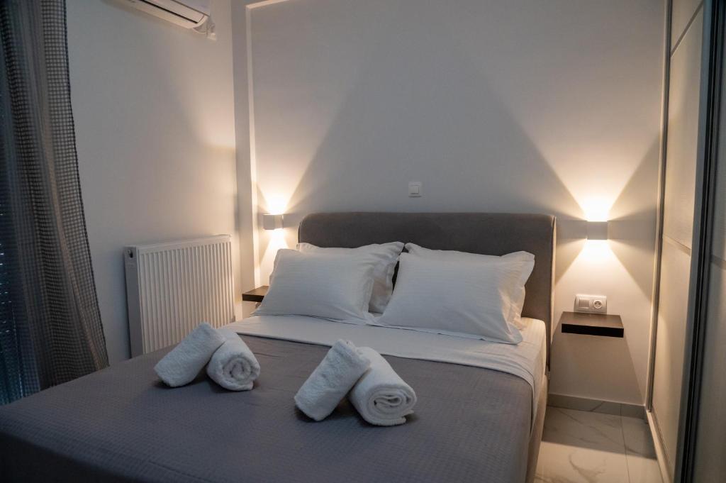 a bedroom with a bed with two towels on it at Central apartment near to Acropolis area in Athens