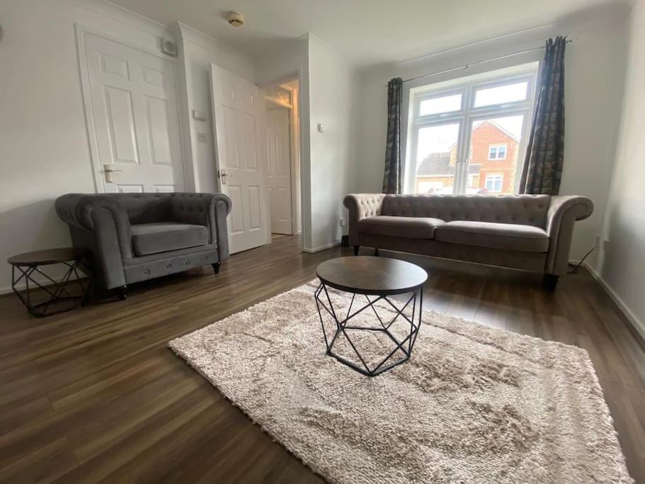a living room with two couches and a table at Charming 3Bed House in Strood in Wainscot