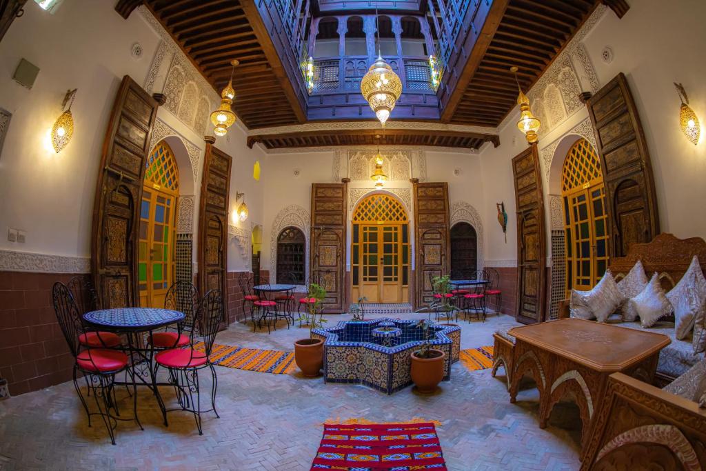 a large room with tables and chairs in a building at Riad Sekaya Fez in Fès