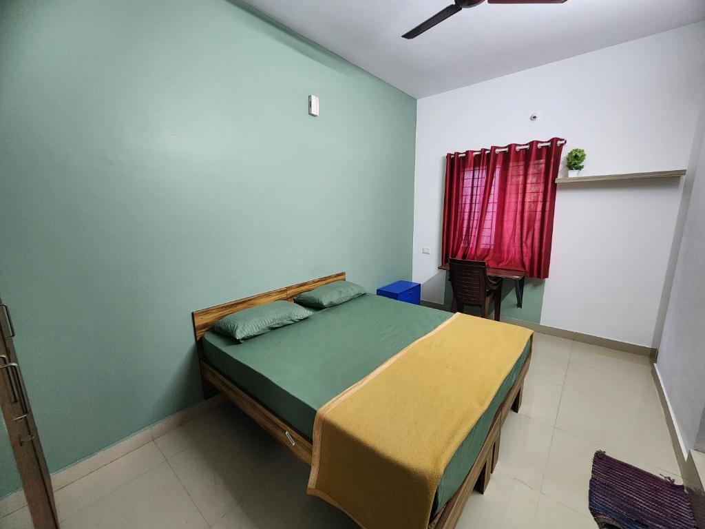 a bedroom with a bed and a red window at SQUARSTAY in Bangalore