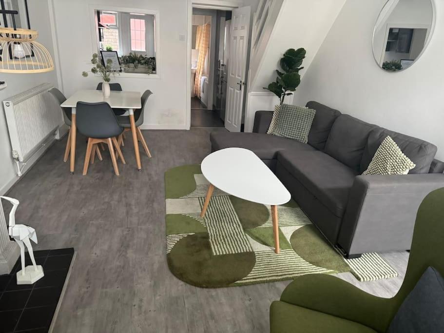 a living room with a couch and a table at Liverpool townhouse sleeps 6 with free on street parking in Liverpool