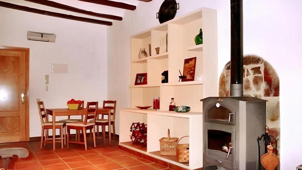 a living room with a fireplace and a table at One bedroom apartement with furnished terrace and wifi at Tolva in Tolva