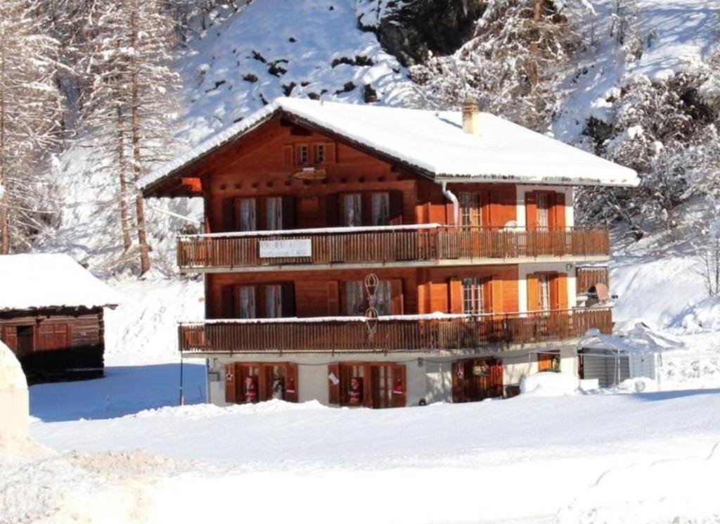 a log cabin in the snow with snow at Chalet Les Rocailles in Haudères