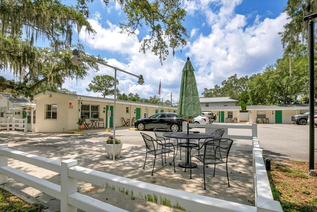 a patio with a table and chairs and a building at Safety Harbor Motel in Safety Harbor