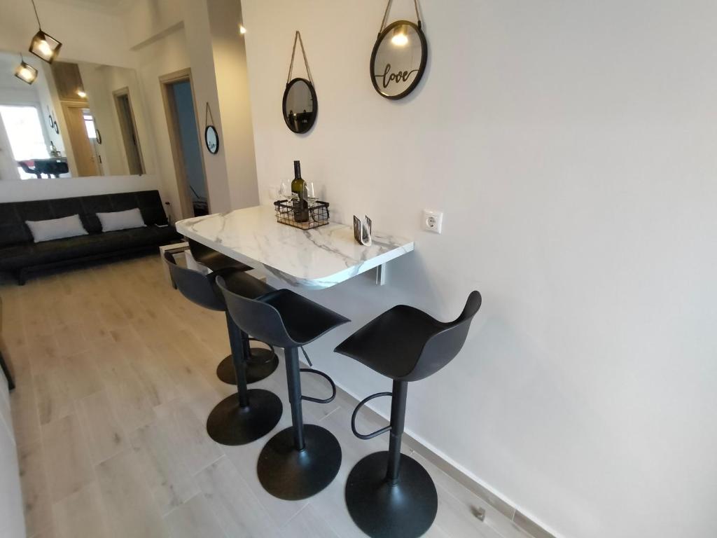 a kitchen with a counter and stools in a room at Luxury sea apartment in Loutraki