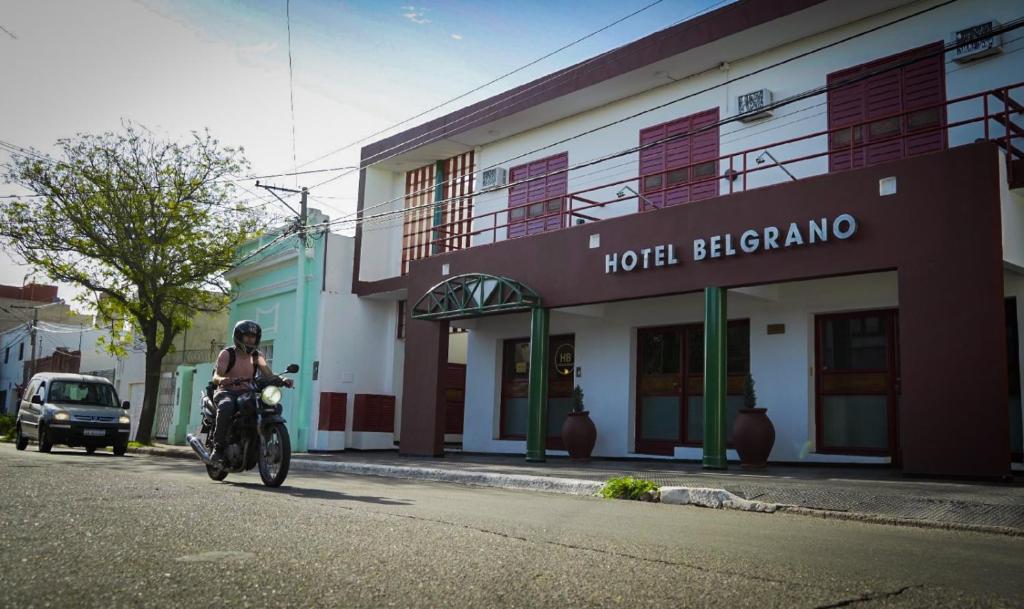 a person riding a motorcycle in front of a hotel blacco at Hotel Belgrano in San Luis