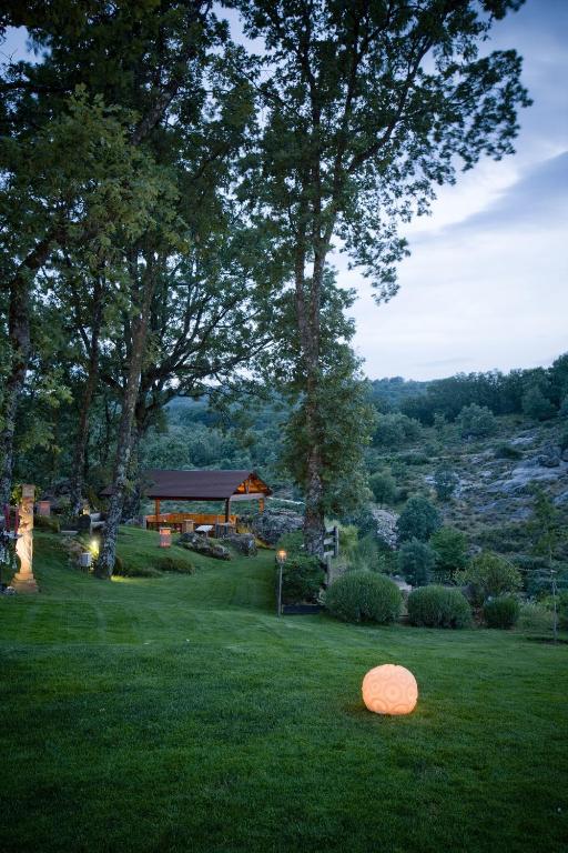 an orange object sitting on the grass in a yard at Hospedium Hotel Rural Ruta Imperial H-CC-00660 in Jarandilla de la Vera