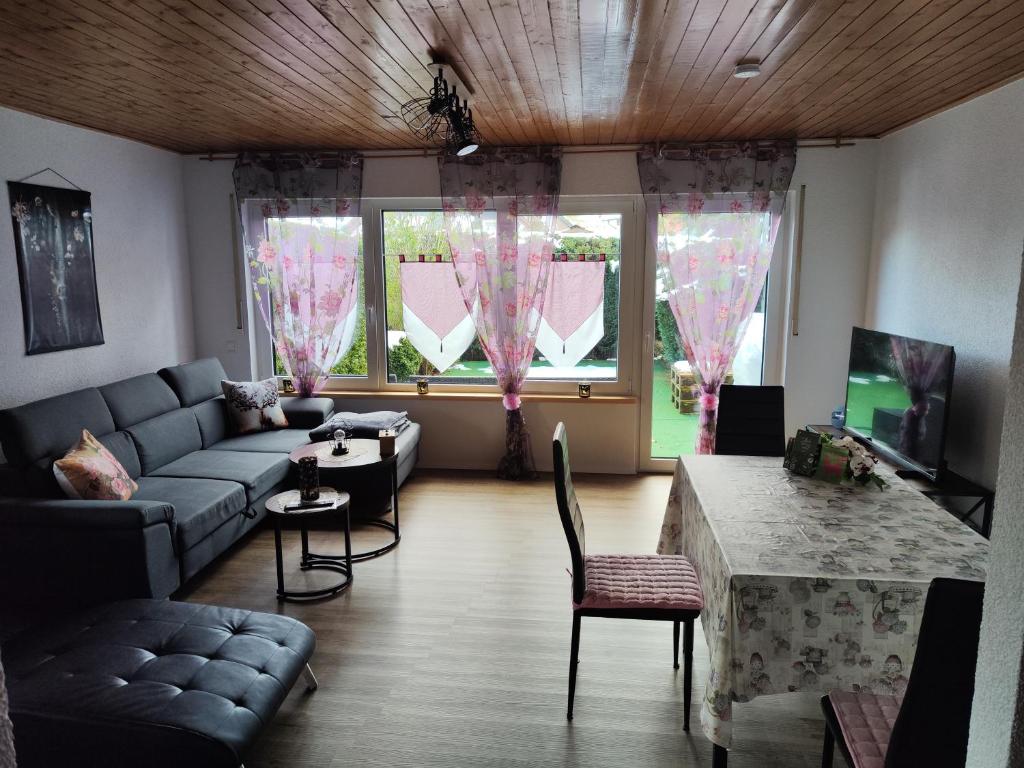 a living room with a couch and a table at Ferienhaus Hermann in Schonwald im Schwarzwald