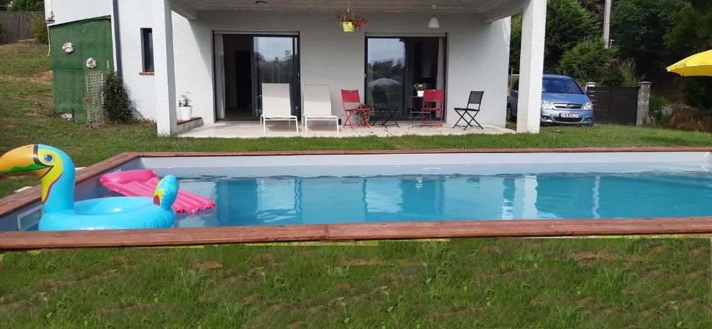 a swimming pool with a toy duck in front of a house at T2 avec Piscine exclusive in Bourg-Saint-Bernard