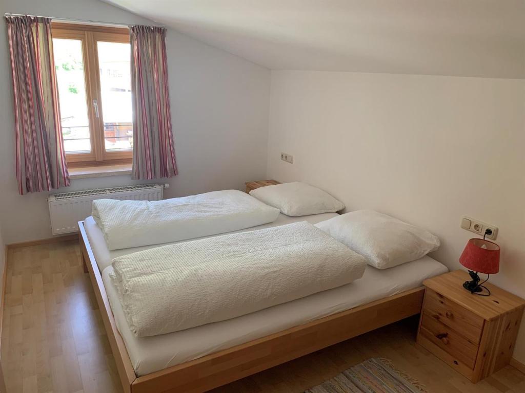 a bed with two pillows on it in a bedroom at Haus Pistenblick in Dienten am Hochkönig