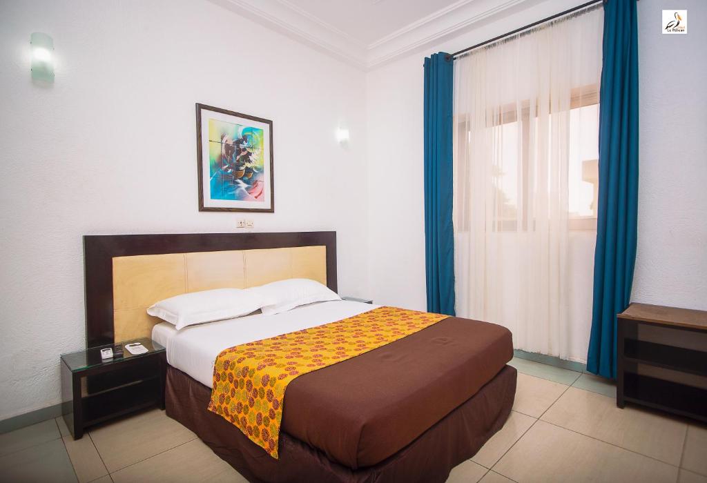 Postel nebo postele na pokoji v ubytování Hotel le Pelican