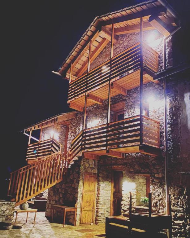 a wooden building with stairs on the side of it at Chalet Valchiavenna in San Cassiano