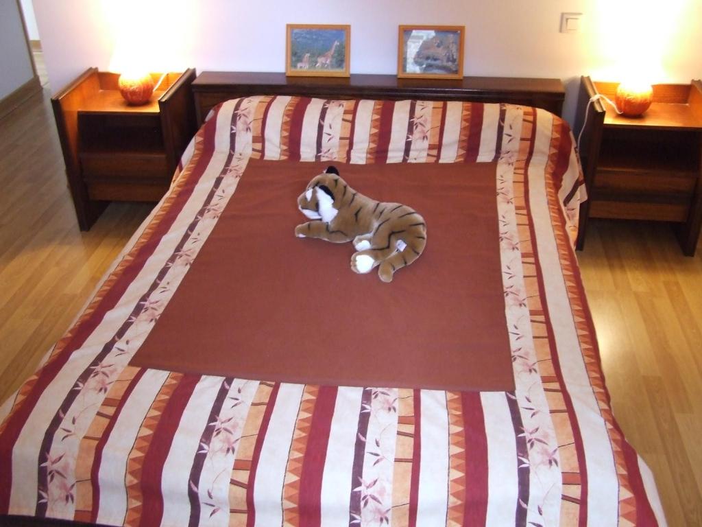 a dog laying on a bed in a bedroom at Les Abris de la Sée in Tirepied