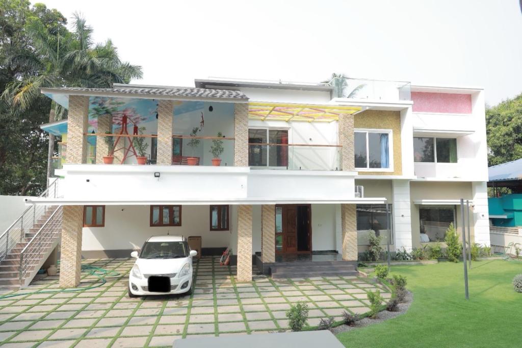 a white car parked in front of a house at Thekkanatt HomeStay in Palghat