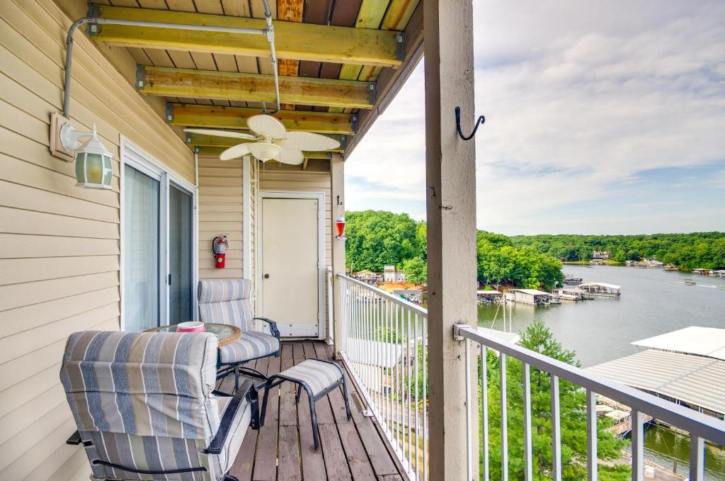 a porch with two chairs and a view of the water at Cozy Lake Ozark Condo Rental with Grill, Pool Access in Lake Ozark