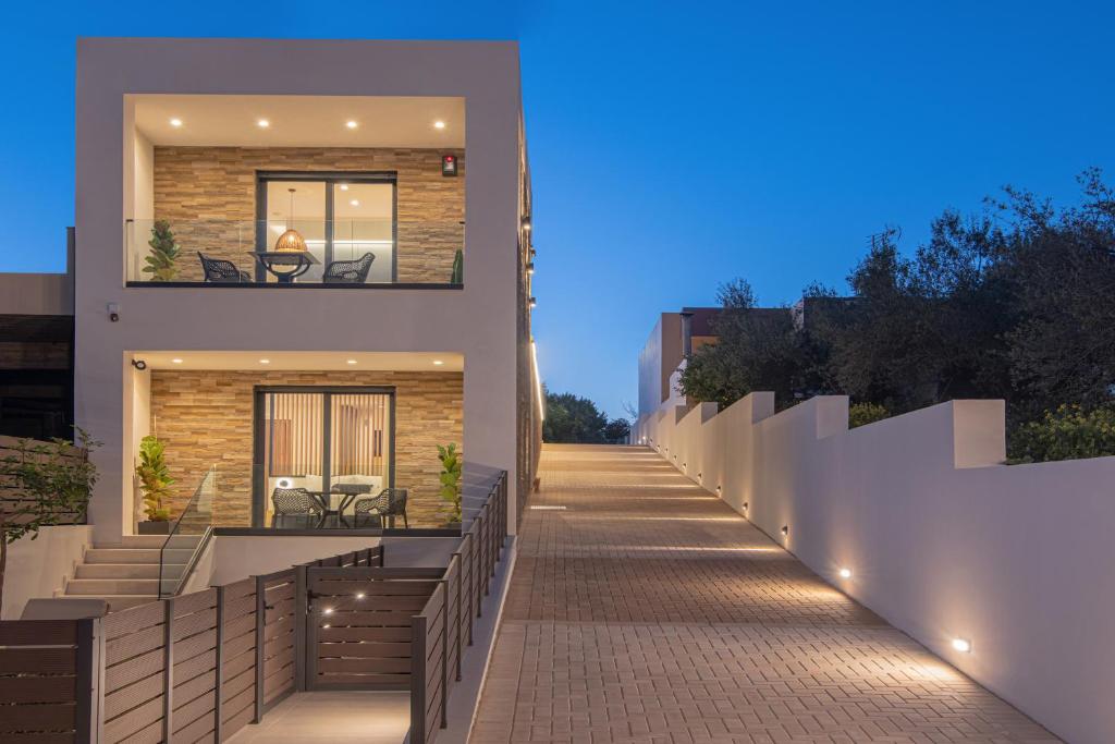 a walkway leading to a house at night at Anantia Luxury Maisonette - Scenic View in Episkopi (Heraklion)