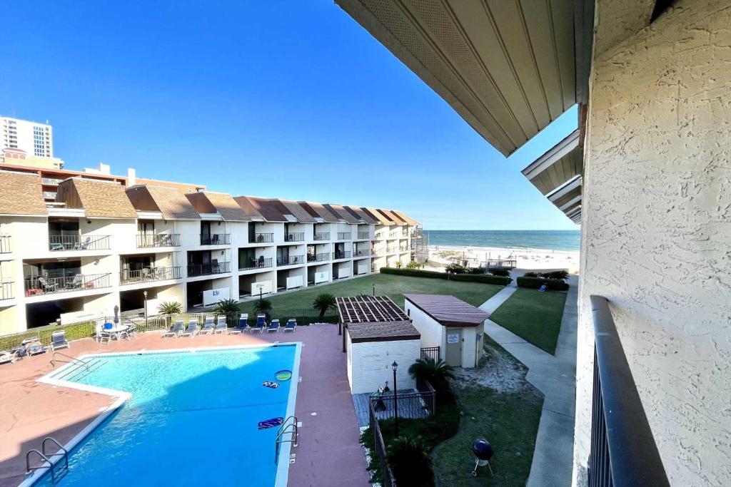 a view of a resort with a swimming pool and the ocean at Gulfside Townhome 13 Townhouse in Gulf Shores