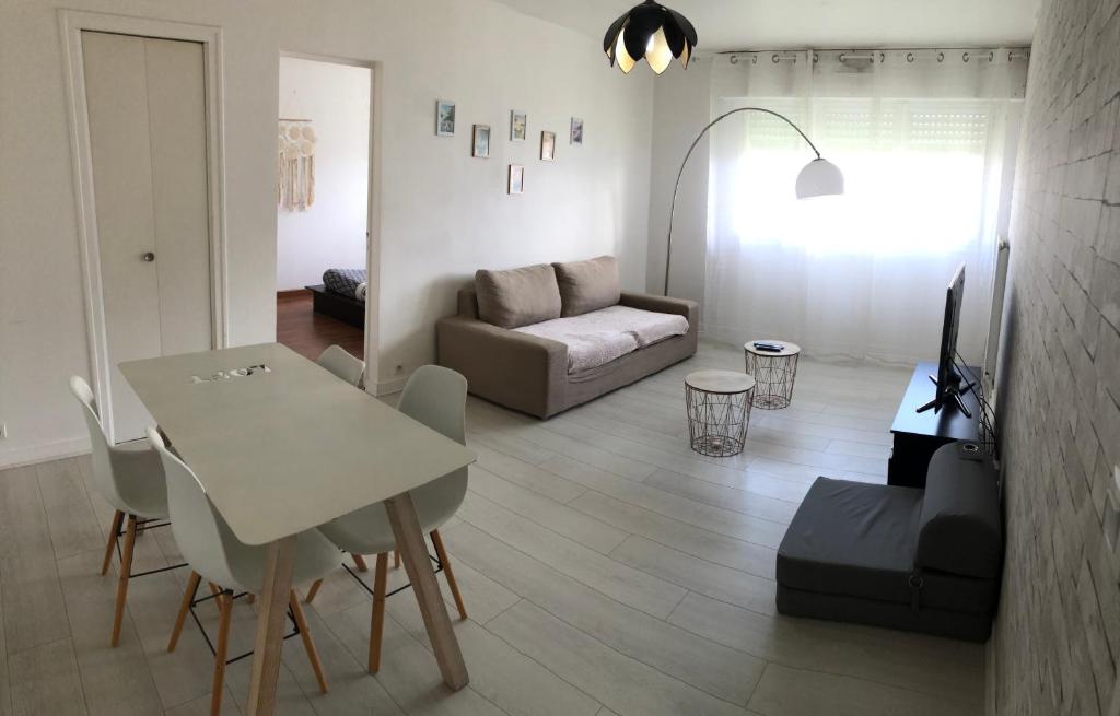 uma sala de estar com uma mesa e um sofá em Appartement Saint-Malo Centre - Arrivée autonome em Saint Malo