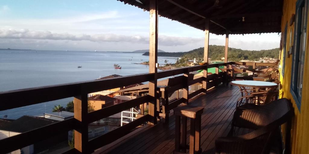 a balcony with a view of the beach and the ocean at Pousada Vida Simples in São Francisco do Sul