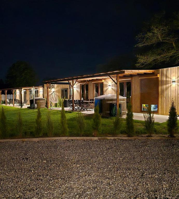 a house with lights on in front of it at night at Nowy York - Sauna - Jacuzzi - Najczystsze jezioro PL - SPA - STYRUŚ in Giewartów