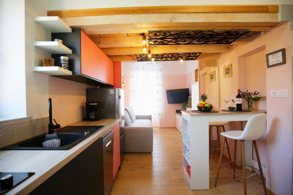 a small kitchen with a counter and a dining room at STUDIO MO in Opatija