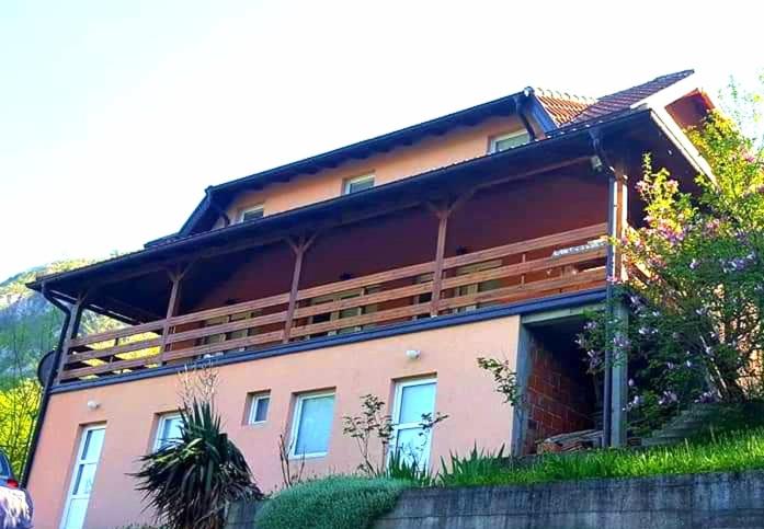 a large house with a balcony on top of it at Apartment Dobra vila in Perućac