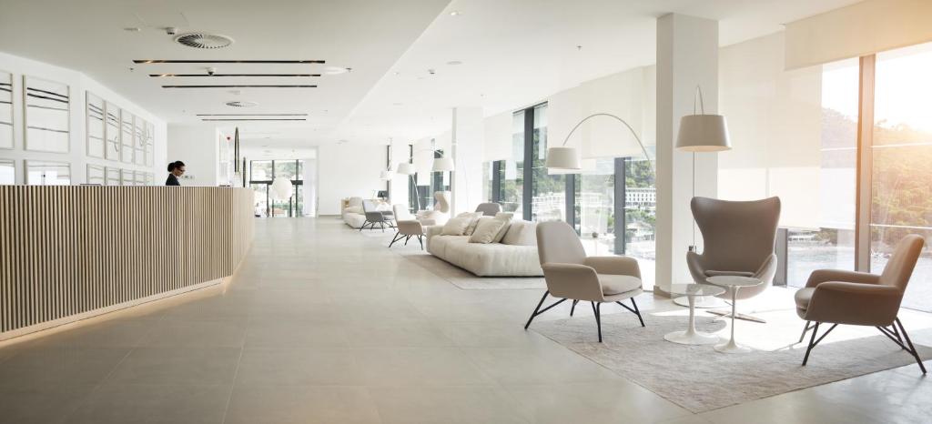a lobby with a couch and chairs in a building at Hotel Kompas in Dubrovnik