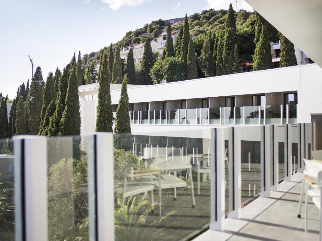 a view from the balcony of a building with trees at Hotel Kompas in Dubrovnik