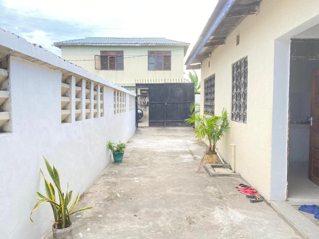 a driveway leading to a house with a garage at Nest Haven Homestay-Hostel in Dar es Salaam