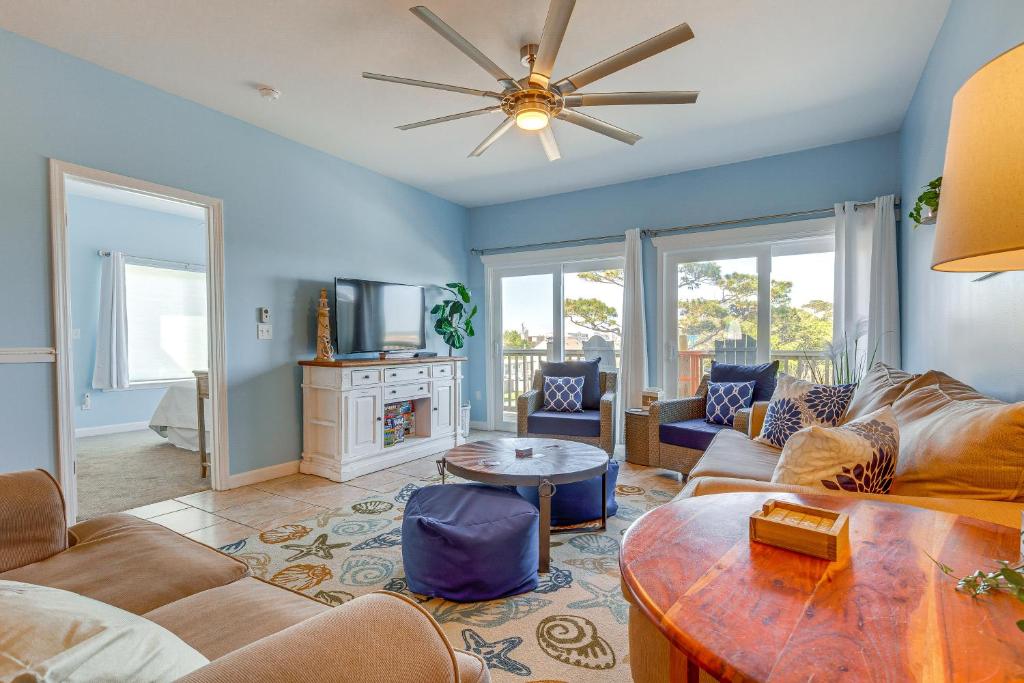 a living room with a couch and a table at Water View Dauphin Island Condo with Boat Slips in Dauphin Island