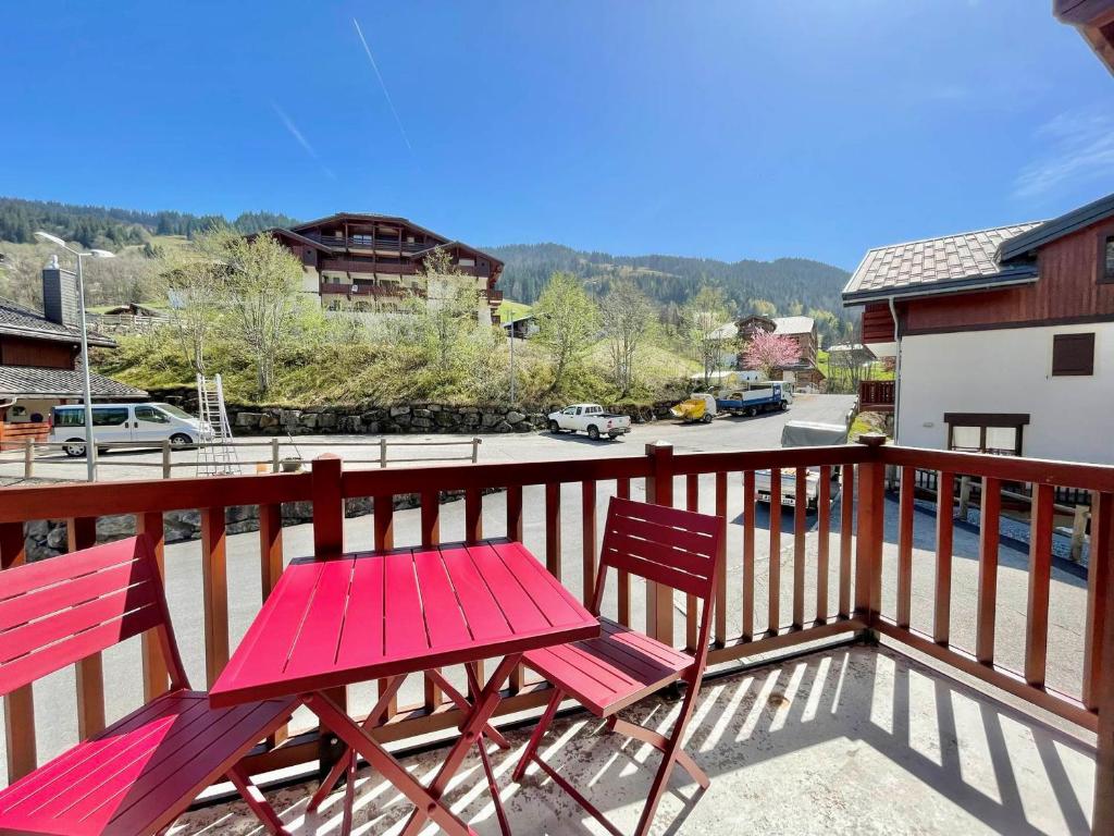 a red table and two chairs on a balcony at Appartement Flumet, 2 pièces, 4 personnes - FR-1-505-206 in Flumet