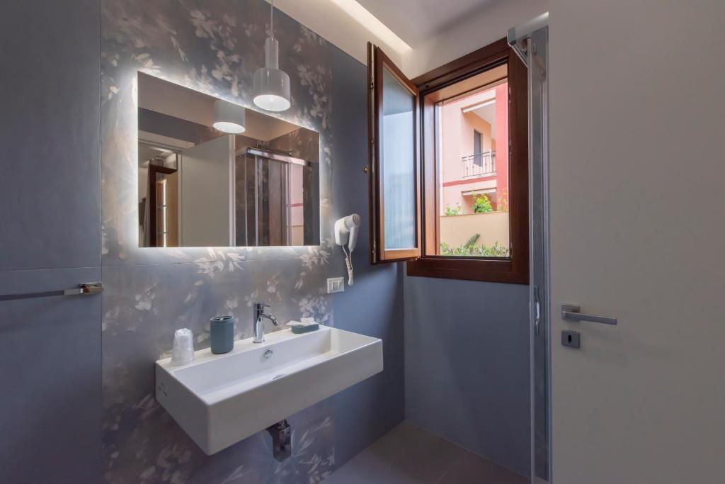 a bathroom with a sink and a mirror at Room & Breakfast Aloe in San Vito lo Capo